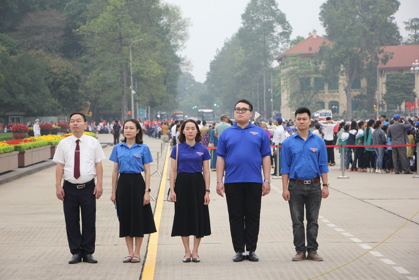 A group of people standing on a street with a crowd watching

Description automatically generated with low confidence