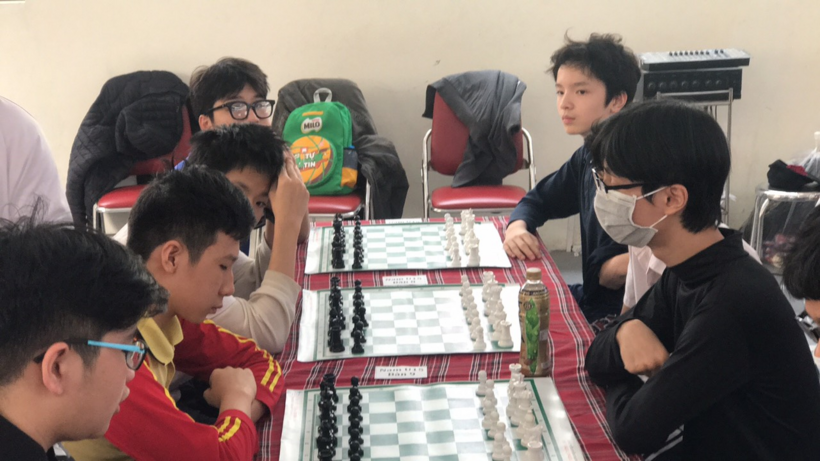 A group of people playing a board game
Description automatically generated with medium confidence