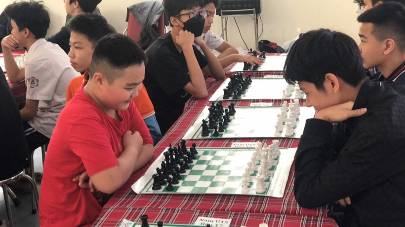 A group of people playing chess
Description automatically generated