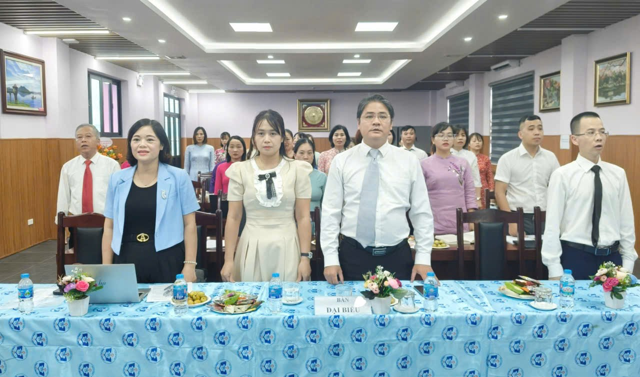 A group of people standing in a room

Description automatically generated