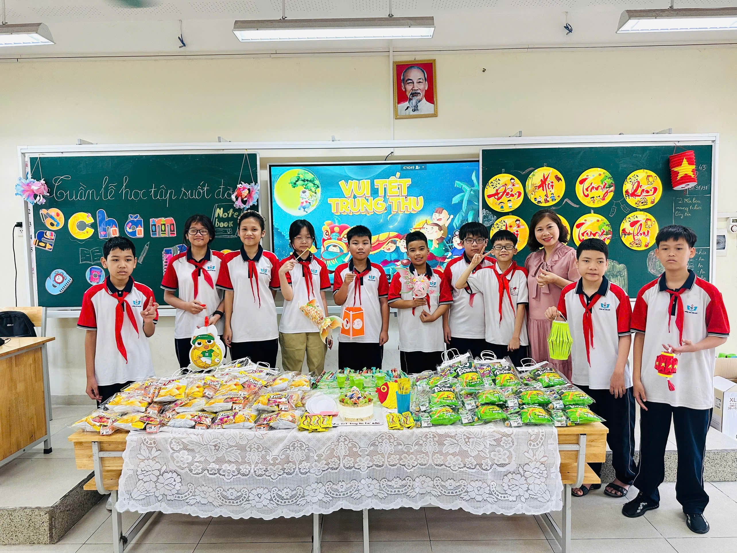 A group of children standing in front of a table with food

Description automatically generated
