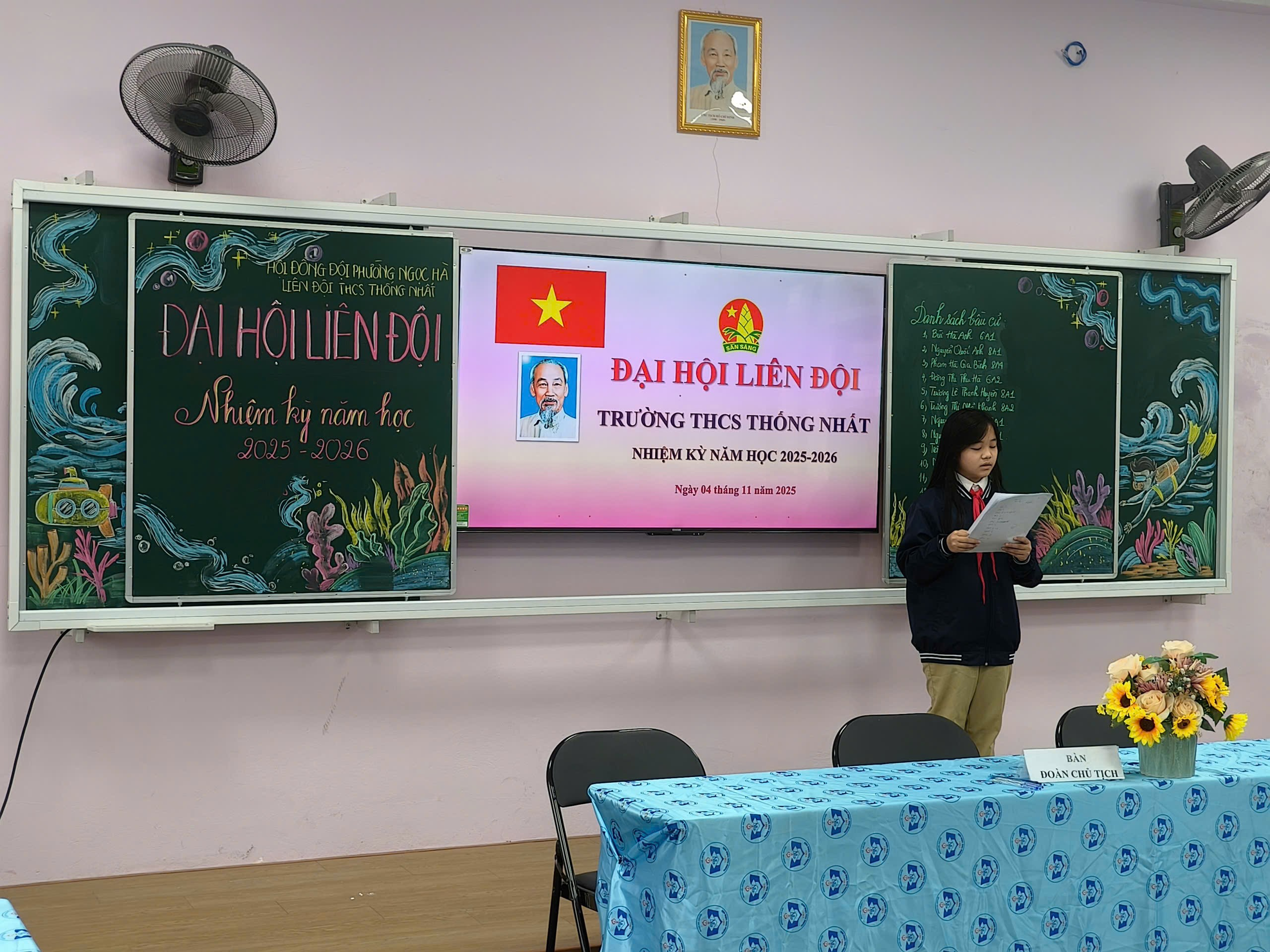 A person standing in front of a chalkboard

Description automatically generated