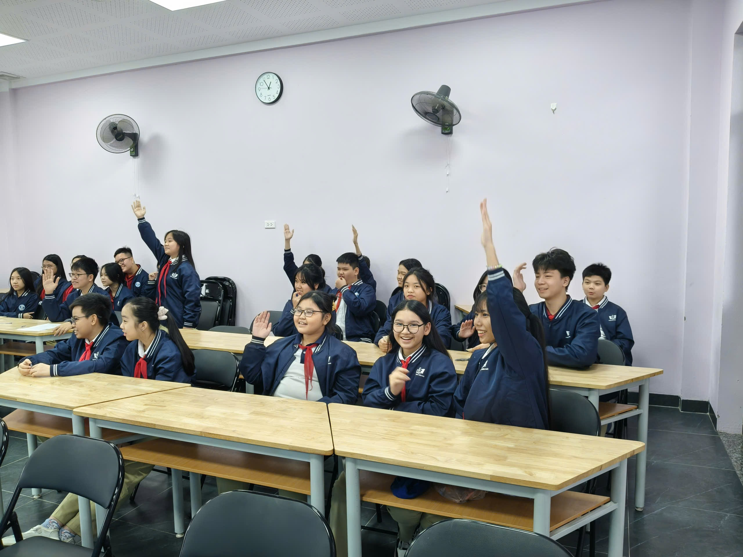 A group of students raising their hands

Description automatically generated