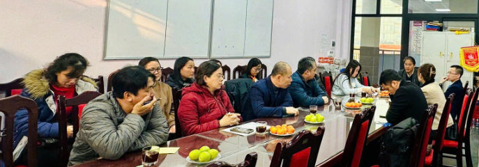 A group of people sitting at a table

Description automatically generated