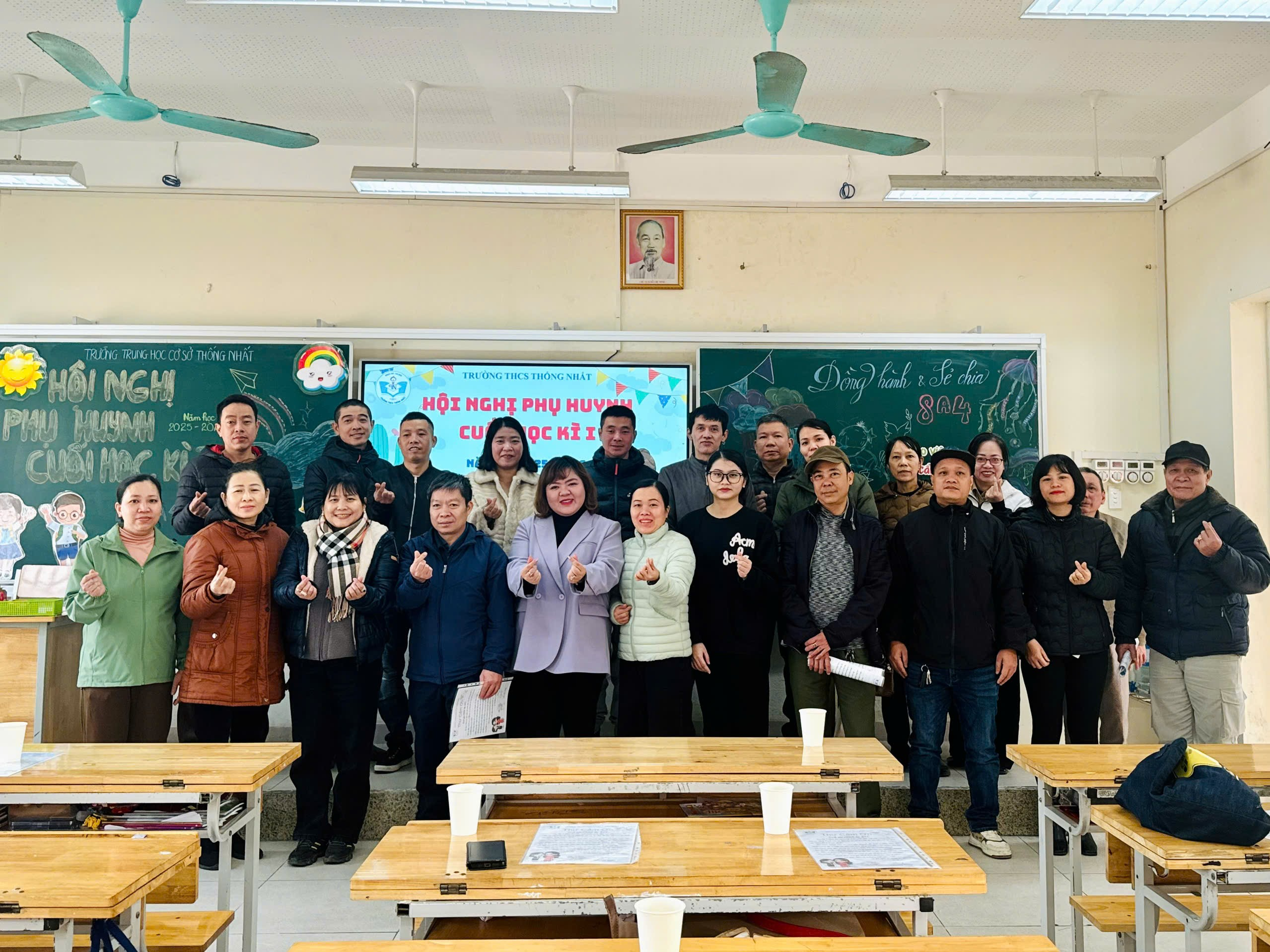 A group of people standing in a classroom

Description automatically generated