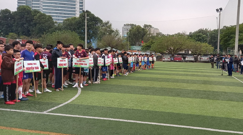 A group of people holding signs on a field

Description automatically generated with medium confidence