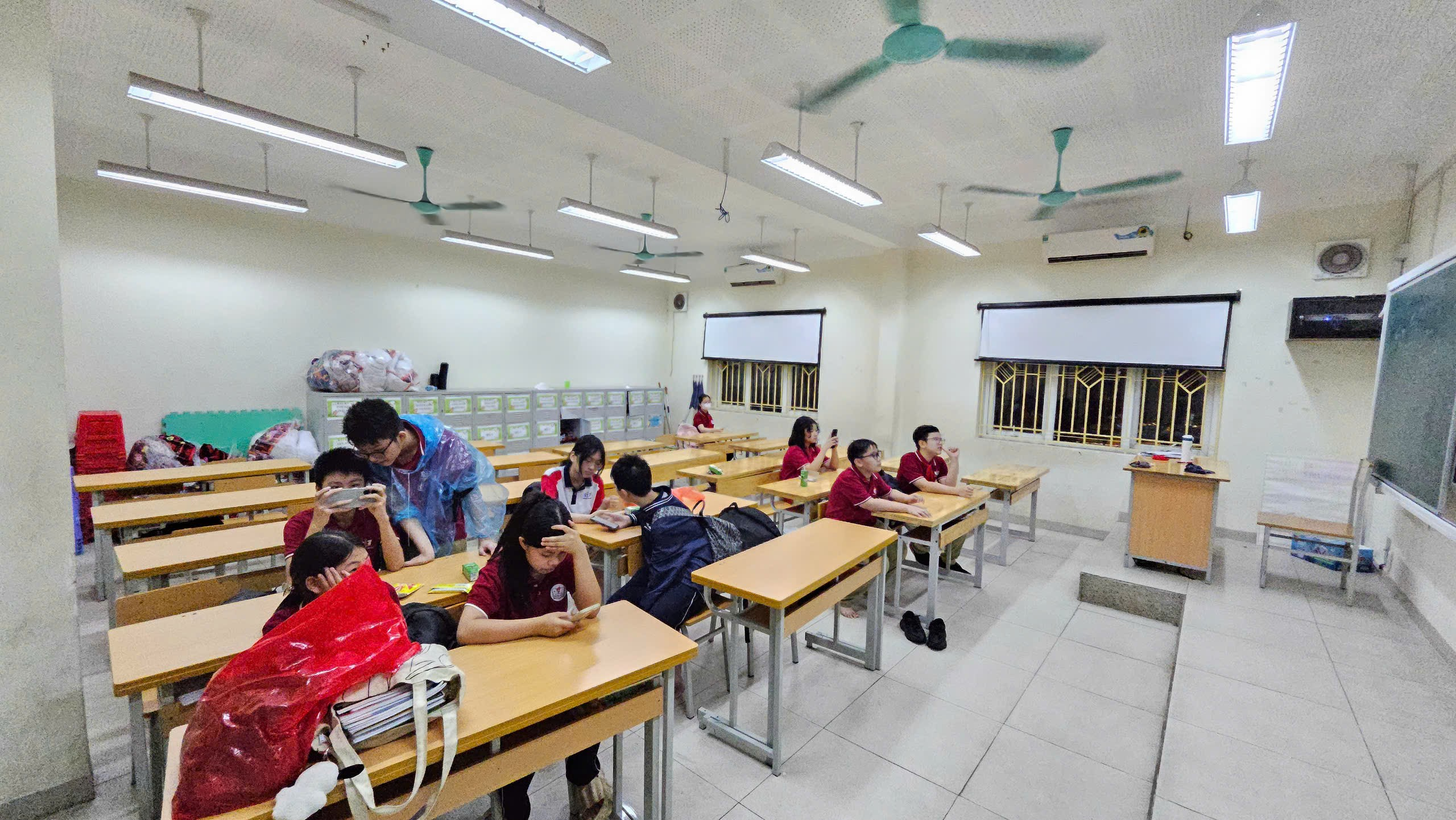 Một nhóm người ngồi ở bàn học trong lớp học  Mô tả được tạo tự động