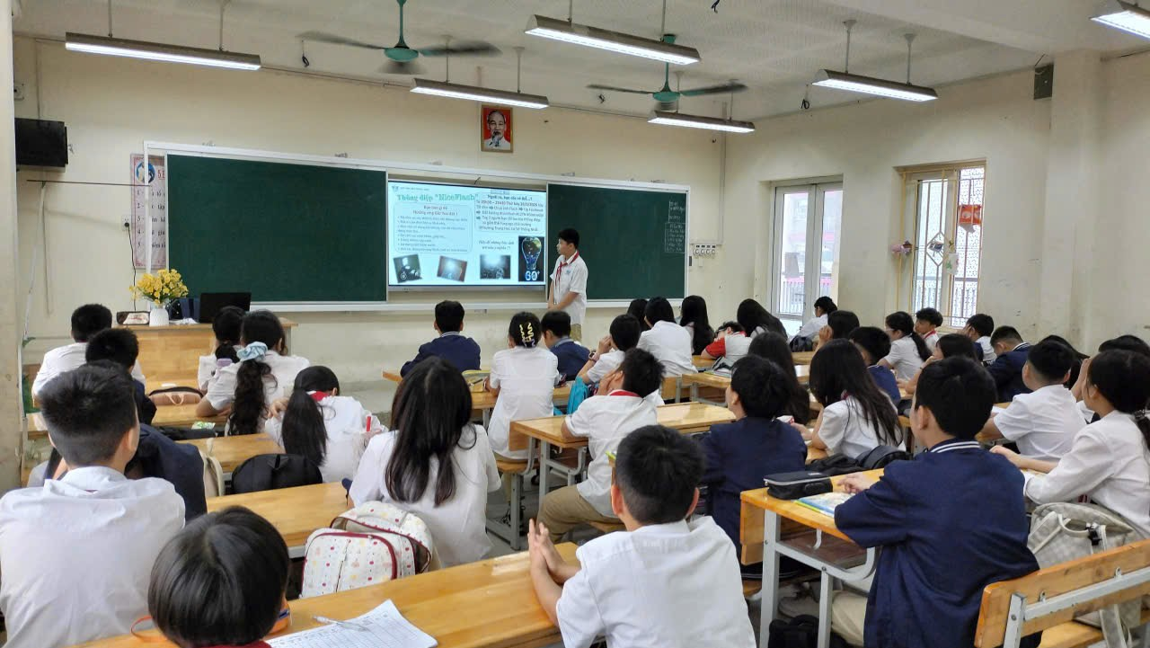 A classroom with students in front of a chalkboard

Description automatically generated